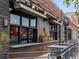 Exterior view of the Root's building with black framed windows, outdoor dining and a flower box at 3715 Kalamath St, Denver, CO 80211