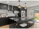 Modern kitchen with a large island, stylish pendant lights, and stainless steel appliances at 3715 Kalamath St, Denver, CO 80211