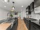 Contemporary kitchen featuring dark cabinetry, a center island, and stainless steel appliances at 3715 Kalamath St, Denver, CO 80211