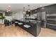 A modern open kitchen with a large island, stainless steel appliances, and an adjacent dining area at 3715 Kalamath St, Denver, CO 80211
