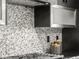 Modern kitchen features stylish backsplash, stainless steel range hood, and sleek countertops at 3715 Kalamath St, Denver, CO 80211