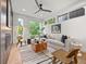Bright living room featuring hardwood floors, stylish furniture, and large windows with outdoor views at 3715 Kalamath St, Denver, CO 80211