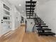 Modern staircase with metal railings, wood floors, and an open design for seamless flow at 3715 Kalamath St, Denver, CO 80211