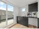 A stylish wet bar with dark cabinetry and sleek countertops enhances the entertainment possibilities of the space at 3715 Kalamath St, Denver, CO 80211