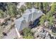 An aerial view of a beautiful gray roof on a house surrounded by large trees and rock formations at 9659 S Turkey Creek Rd, Morrison, CO 80465