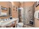 Bathroom featuring a glass shower, stone tile, and stylish sink at 9659 S Turkey Creek Rd, Morrison, CO 80465