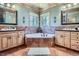 Bathroom with dual sinks, a jacuzzi tub, and plenty of natural light at 9659 S Turkey Creek Rd, Morrison, CO 80465