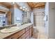Spacious bathroom featuring a double vanity, tiled bathtub, and a separate shower, offering ample space at 9659 S Turkey Creek Rd, Morrison, CO 80465