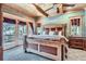 Bedroom with wooden beams, large windows, and patio access for scenic views at 9659 S Turkey Creek Rd, Morrison, CO 80465