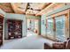 Cozy sitting area inside the bedroom with fireplace views, large windows, and access to an outdoor balcony at 9659 S Turkey Creek Rd, Morrison, CO 80465