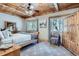 Cozy bedroom featuring a wooden ceiling, neutral walls, and natural light from two windows at 9659 S Turkey Creek Rd, Morrison, CO 80465