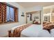 Cozy bedroom with a decorative bedspread, wood accents, and a sliding door closet at 9659 S Turkey Creek Rd, Morrison, CO 80465
