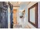 Welcoming foyer with a decorative front door, a large mirror, and an open view into the living spaces at 9659 S Turkey Creek Rd, Morrison, CO 80465