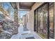 Elegant front entrance featuring a decorative wood door, stone accents, and a covered walkway at 9659 S Turkey Creek Rd, Morrison, CO 80465