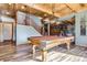 Well-lit game room with a billiards table, wood floors, and a cozy atmosphere at 9659 S Turkey Creek Rd, Morrison, CO 80465
