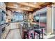 Gourmet kitchen featuring custom wood cabinetry, a large center island with stools, and stainless steel appliances at 9659 S Turkey Creek Rd, Morrison, CO 80465