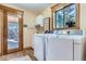Well-lit laundry area with modern washer and dryer near the window with a view at 9659 S Turkey Creek Rd, Morrison, CO 80465