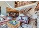 Spacious living room with vaulted ceilings, wood accents, an open staircase, and comfortable seating at 9659 S Turkey Creek Rd, Morrison, CO 80465