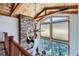 Great room features vaulted wood ceilings, stacked stone fireplace, and mountain views at 9659 S Turkey Creek Rd, Morrison, CO 80465