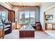 Main bathroom featuring a large soaking tub with jets, picturesque window, vanity seating, and a built-in cabinet at 9659 S Turkey Creek Rd, Morrison, CO 80465