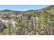 A scenic view of rolling hills covered in lush green trees at 9659 S Turkey Creek Rd, Morrison, CO 80465