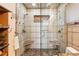 Updated bathroom with glass enclosed shower, tile walls and floor with built-in seating at 8090 Newton St, Westminster, CO 80031