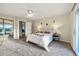 Bedroom with carpet, ceiling fan, and sliding glass doors to balcony at 8090 Newton St, Westminster, CO 80031