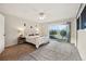 Bright bedroom with carpet, ceiling fan, and sliding glass doors to balcony at 8090 Newton St, Westminster, CO 80031