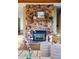 Close-up of a stone fireplace with a mantel, decorative items, and nearby seating at 8090 Newton St, Westminster, CO 80031