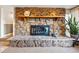 Stone fireplace with wood mantle shelf and displayed decorations at 8090 Newton St, Westminster, CO 80031