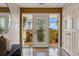 Elegant foyer featuring a decorative front door with sidelights, tile floors, and views of the outdoor deck at 8090 Newton St, Westminster, CO 80031