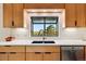 Kitchen with garden window, tile backsplash, stainless appliances, and custom cabinetry at 8090 Newton St, Westminster, CO 80031