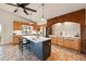 Kitchen with vaulted ceiling, stainless appliances, breakfast bar, brick arch and tile floors at 8090 Newton St, Westminster, CO 80031