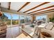 Bright living room with exposed wood beams, large windows offering scenic views, and stylish furnishings at 8090 Newton St, Westminster, CO 80031