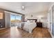Spacious main bedroom with hardwood floors, sliding glass doors to deck, and ceiling fan at 8090 Newton St, Westminster, CO 80031