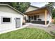 View of home's backyard, including the covered patio and outdoor living space at 4711 S Logan St, Englewood, CO 80113