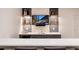 Stylish basement bar featuring a stone backsplash, modern cabinetry, and an entertainment area at 4711 S Logan St, Englewood, CO 80113