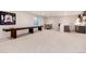 Finished basement with a shuffleboard table, bar seating, bar and refreshment area, and a large window at 4711 S Logan St, Englewood, CO 80113