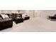 Finished basement with a large leather sectional sofa, and a table on a white carpet at 4711 S Logan St, Englewood, CO 80113
