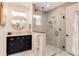Bathroom features a glass-enclosed shower, granite countertop, navy blue cabinets, and gold hardware at 4711 S Logan St, Englewood, CO 80113