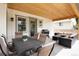 Relax on the covered patio with an outdoor kitchen and comfortable seating area at 4711 S Logan St, Englewood, CO 80113