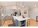 Modern kitchen with stainless appliances, large center island with barstool seating, and open design at 4711 S Logan St, Englewood, CO 80113