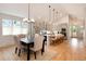 Open kitchen and dining area boasts stainless appliances, a large island, and hardwood floors at 4711 S Logan St, Englewood, CO 80113