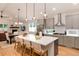 Spacious kitchen featuring a large island with barstool seating and modern stainless steel appliances at 4711 S Logan St, Englewood, CO 80113