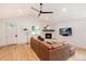 Bright living room features a leather sectional sofa, fireplace, and hardwood floors at 4711 S Logan St, Englewood, CO 80113