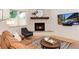 Cozy living room featuring stone fireplace with wood mantle and modern furnishings at 4711 S Logan St, Englewood, CO 80113