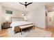 Bright main bedroom features a bed, hardwood floors, and modern décor at 4711 S Logan St, Englewood, CO 80113