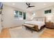 Comfortable main bedroom features a large window, hardwood floors, and contemporary furnishings at 4711 S Logan St, Englewood, CO 80113