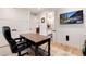 Office featuring a wooden desk, leather chair, and a view of a bathroom with a granite countertop at 4711 S Logan St, Englewood, CO 80113