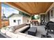 Inviting covered patio with modern seating, outdoor dining, and a well-maintained backyard at 4711 S Logan St, Englewood, CO 80113